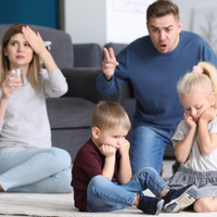 Children looking upset while their parents argue, highlighting the emotional impact of narcissistic parents on a child’s self-esteem.